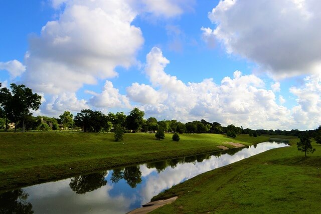 Spectacular view of a Bayou Trees, rever and cloudy sky in Houston, TX